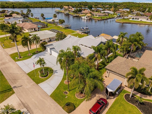 drone / aerial view with a water view and a residential view