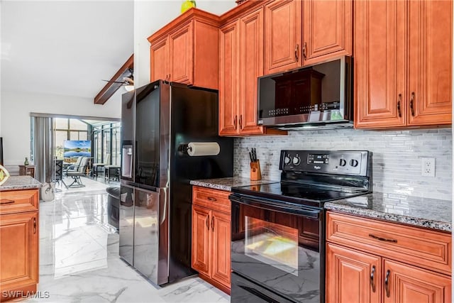 kitchen featuring refrigerator with ice dispenser, brown cabinetry, dark stone countertops, marble finish floor, and electric range