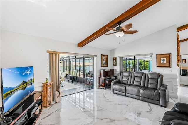 living area featuring marble finish floor, a healthy amount of sunlight, and a ceiling fan
