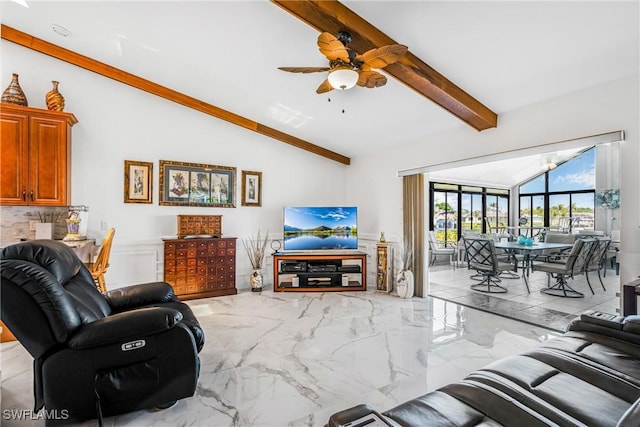 living area featuring lofted ceiling with beams, marble finish floor, and ceiling fan