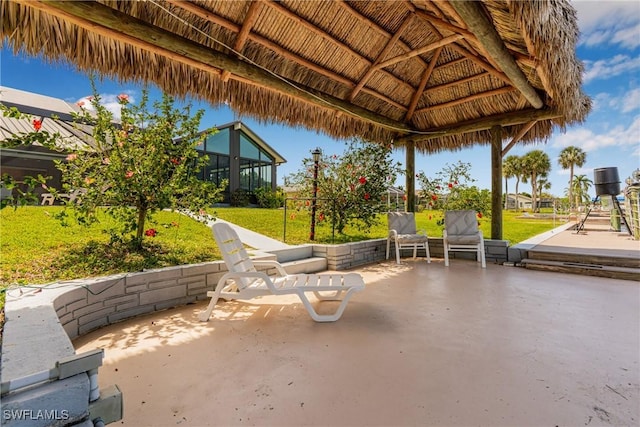 view of patio with glass enclosure and a gazebo