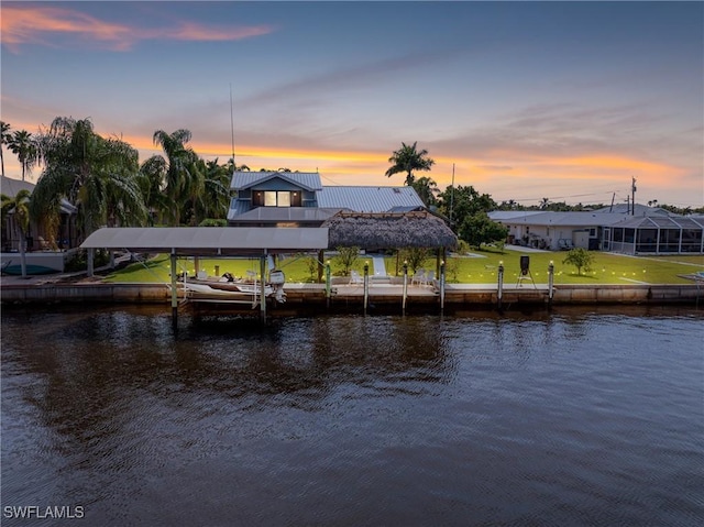 dock area featuring a water view and a yard