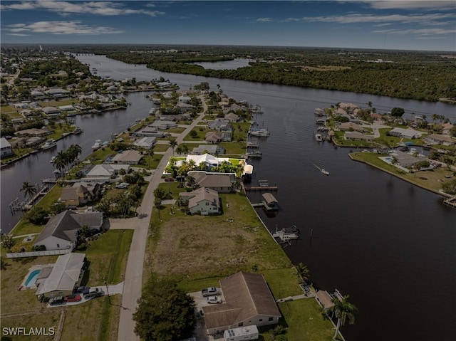 drone / aerial view featuring a residential view and a water view