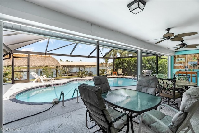 view of swimming pool featuring outdoor dining space, a lanai, and a patio area