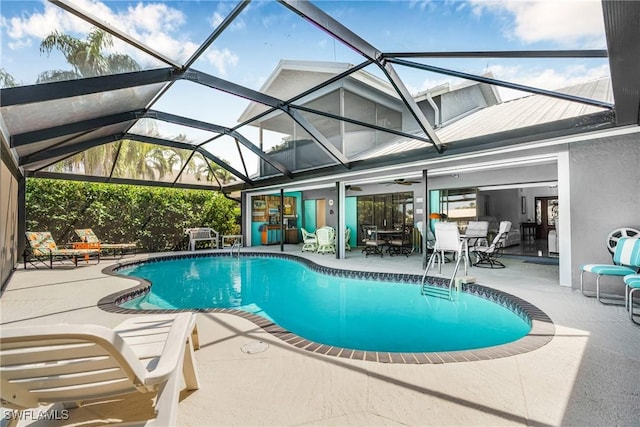pool featuring a lanai, a patio, and a ceiling fan