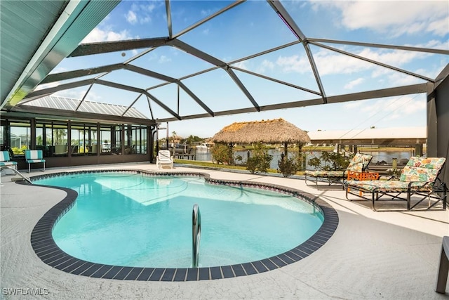pool with glass enclosure and a patio area