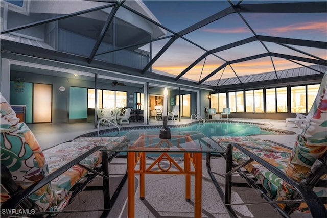 outdoor pool with a ceiling fan, outdoor dining area, a lanai, and a patio