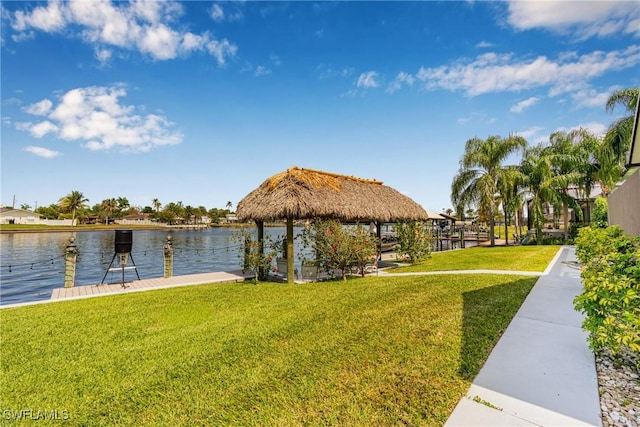 view of dock featuring a water view, a gazebo, and a yard