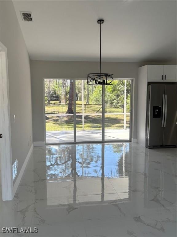 4430 18th Ave NE, Naples, FL 34120 - unfurnished dining area with a notable chandelier, visible vents, marble finish floor, and baseboards