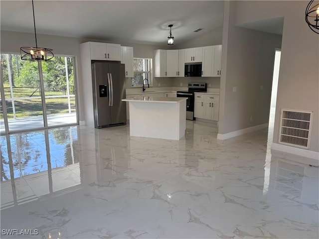 4430 18th Ave NE, Naples, FL 34120 - kitchen with visible vents, a notable chandelier, electric stove, a sink, and stainless steel fridge