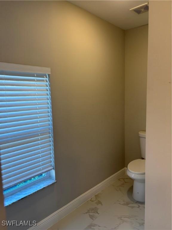 4430 18th Ave NE, Naples, FL 34120 - bathroom featuring visible vents, marble finish floor, toilet, and baseboards