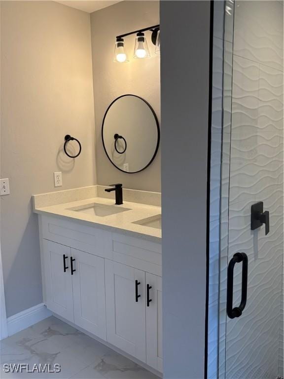 4430 18th Ave NE, Naples, FL 34120 - full bathroom with marble finish floor, a sink, a shower stall, double vanity, and baseboards
