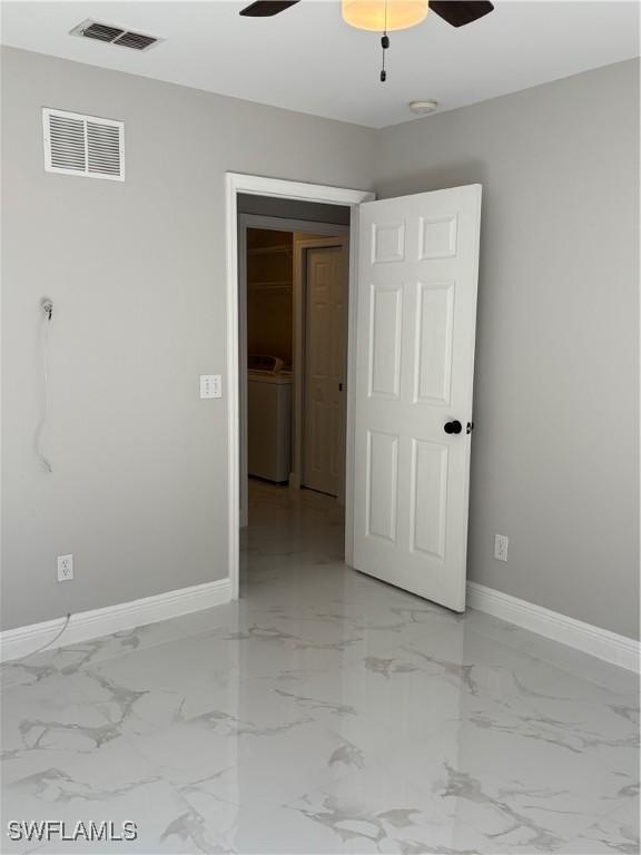 4430 18th Ave NE, Naples, FL 34120 - unfurnished room with washer / dryer, baseboards, visible vents, and ceiling fan
