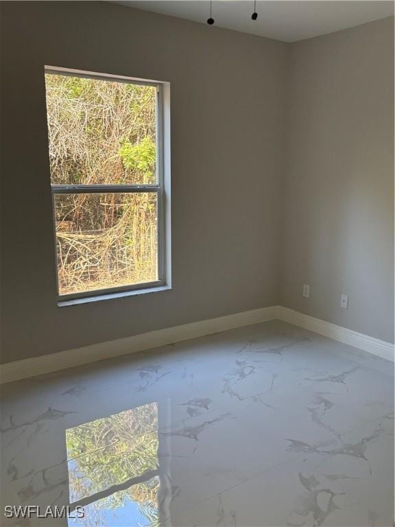4430 18th Ave NE, Naples, FL 34120 - empty room featuring baseboards and marble finish floor