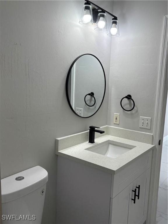 4430 18th Ave NE, Naples, FL 34120 - half bath featuring toilet and vanity