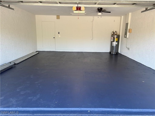 4430 18th Ave NE, Naples, FL 34120 - garage with a garage door opener, a textured wall, and electric water heater