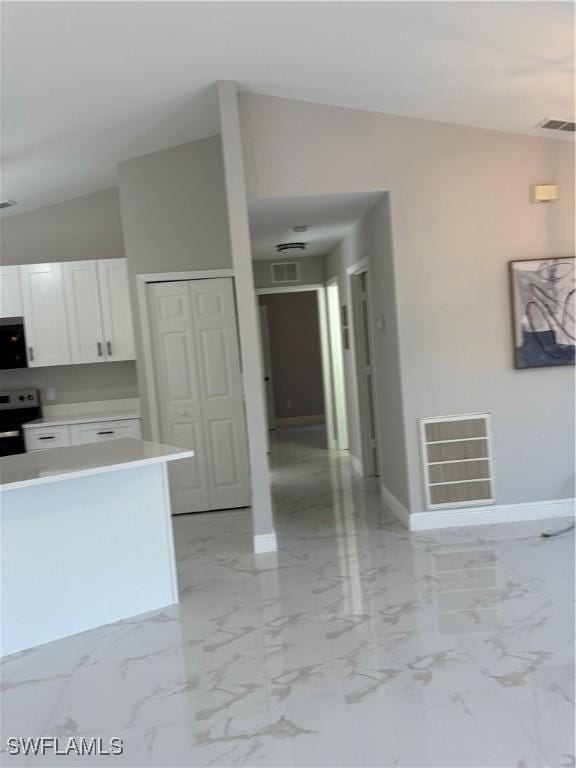 4430 18th Ave NE, Naples, FL 34120 - kitchen with visible vents, marble finish floor, stainless steel electric range, and white cabinetry