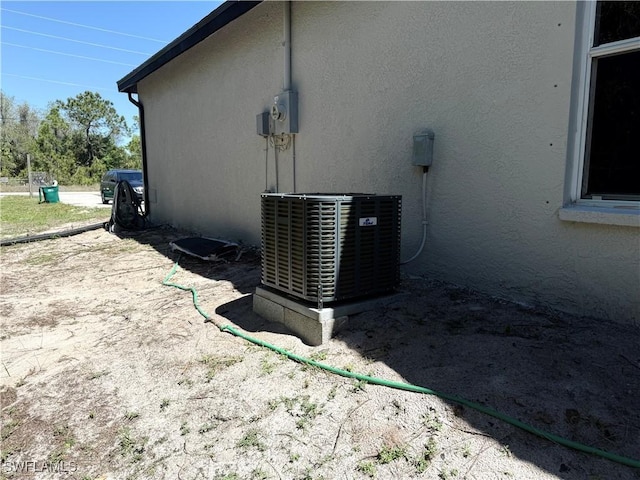 4430 18th Ave NE, Naples, FL 34120 - exterior details with stucco siding and central AC unit