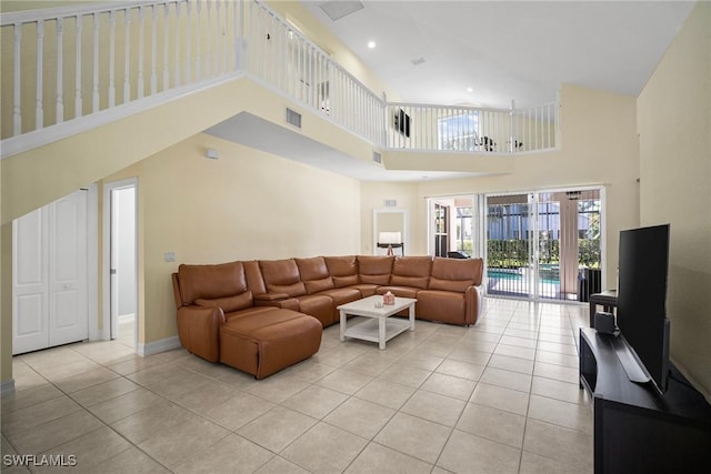 9954 Alabama St, Bonita Springs, FL 34135 - living room featuring light tile patterned floors, visible vents, a high ceiling, and baseboards
