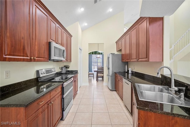 9954 Alabama St, Bonita Springs, FL 34135 - kitchen featuring high vaulted ceiling, a sink, dark stone countertops, appliances with stainless steel finishes, and light tile patterned floors
