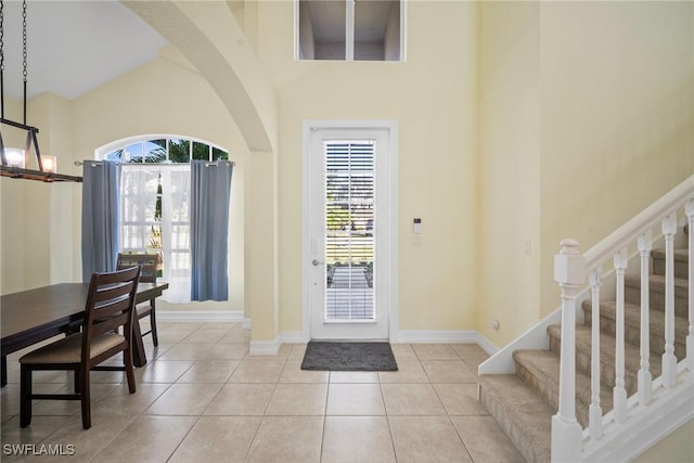 9954 Alabama St, Bonita Springs, FL 34135 - tiled foyer featuring plenty of natural light, stairway, a high ceiling, and baseboards