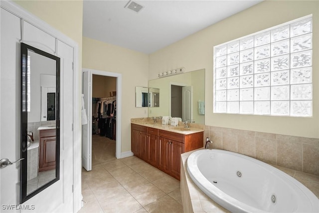 9954 Alabama St, Bonita Springs, FL 34135 - bathroom featuring visible vents, a sink, a tub with jets, tile patterned flooring, and double vanity