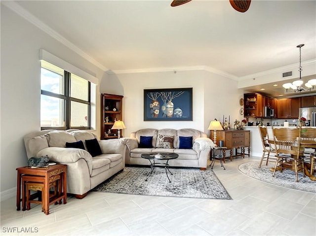 living area with visible vents, ceiling fan with notable chandelier, and ornamental molding