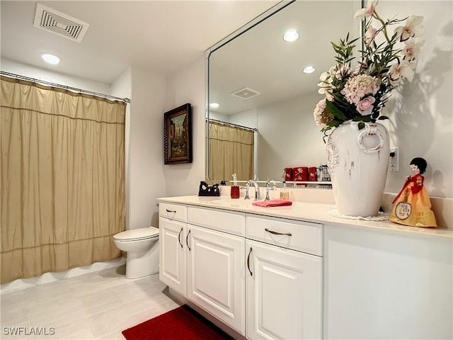 full bath featuring vanity, toilet, recessed lighting, and visible vents