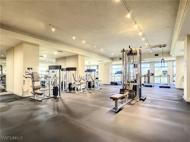 exercise room featuring track lighting and baseboards