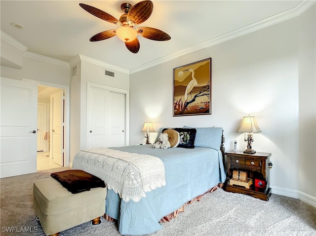bedroom with visible vents, a closet, carpet floors, crown molding, and baseboards