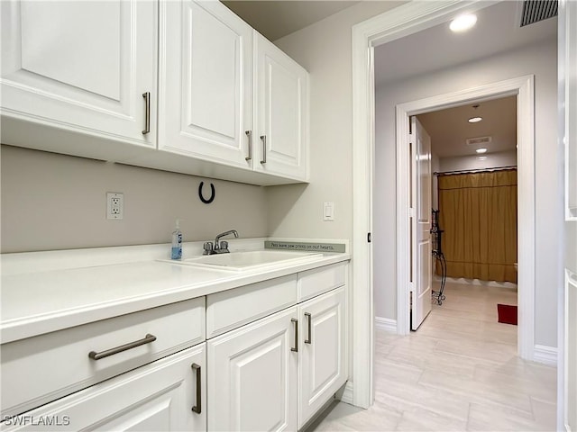 kitchen featuring light countertops, white cabinets, recessed lighting, and visible vents