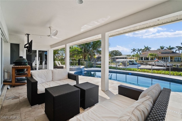 view of patio with a ceiling fan, a pool with connected hot tub, and an outdoor living space