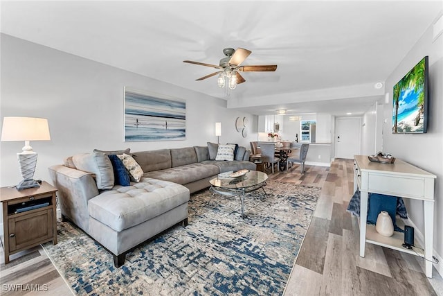 4200 Belair Ln Unit 303, Naples, FL 34103 - living room with light wood-style flooring and ceiling fan