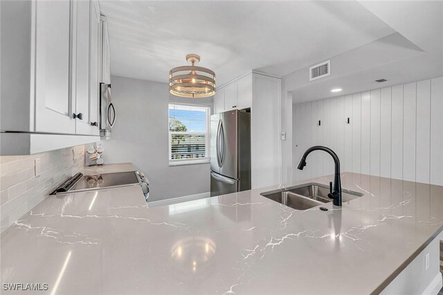 4200 Belair Ln Unit 303, Naples, FL 34103 - kitchen with white cabinets, visible vents, appliances with stainless steel finishes, and a sink