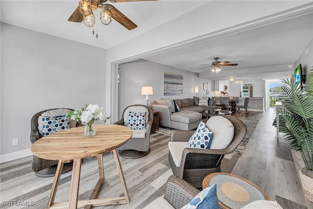 4200 Belair Ln Unit 303, Naples, FL 34103 - living area featuring light wood-style floors, baseboards, and ceiling fan