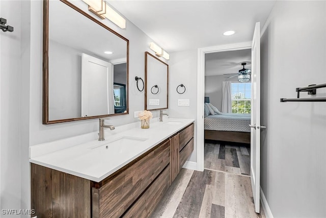 4200 Belair Ln Unit 303, Naples, FL 34103 - full bath featuring a sink, ensuite bathroom, wood finished floors, and double vanity