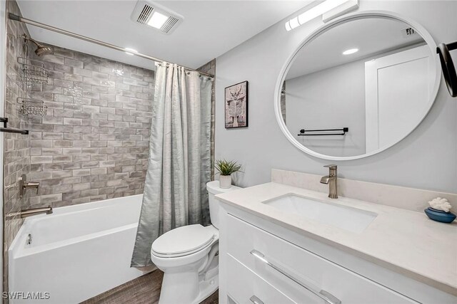 4200 Belair Ln Unit 303, Naples, FL 34103 - bathroom featuring visible vents, vanity, toilet, and shower / tub combo with curtain