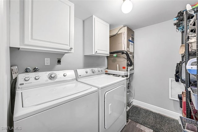 4200 Belair Ln Unit 303, Naples, FL 34103 - laundry room featuring cabinet space, washing machine and dryer, and baseboards