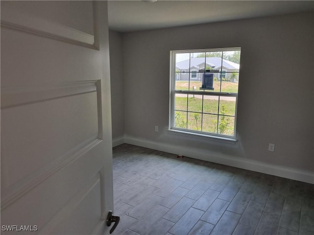 1127 NW 14th Ter, Cape Coral, FL 33993 - empty room with baseboards and wood finished floors