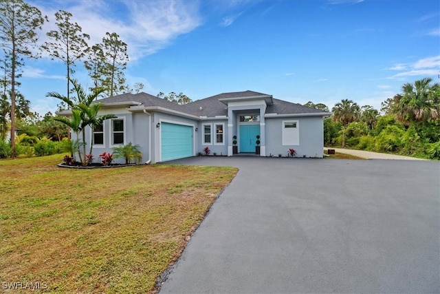 2312 4th Ave SE, Naples, FL 34117 - view of front of property with driveway, stucco siding, an attached garage, and a front lawn