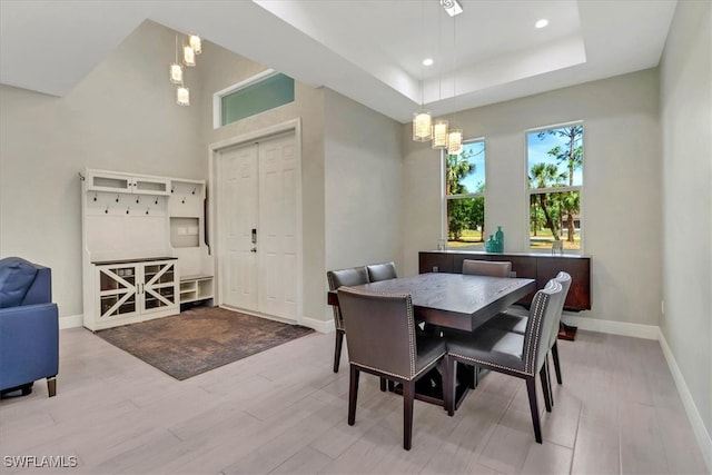 2312 4th Ave SE, Naples, FL 34117 - dining area featuring a notable chandelier, baseboards, recessed lighting, a raised ceiling, and wood finished floors
