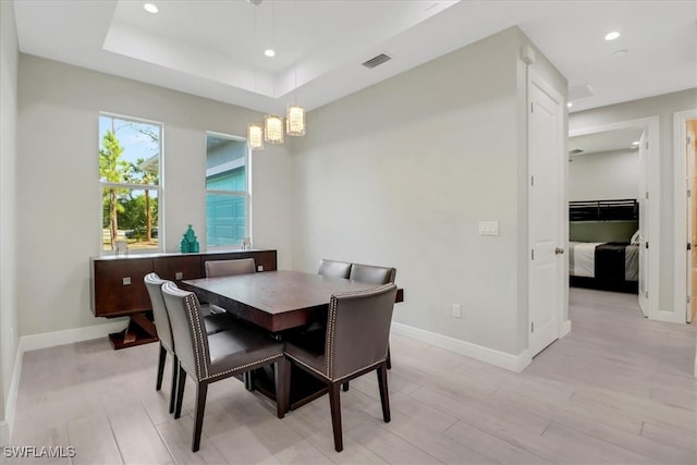 2312 4th Ave SE, Naples, FL 34117 - dining space featuring a tray ceiling, recessed lighting, light wood-type flooring, and baseboards