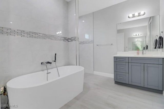 2312 4th Ave SE, Naples, FL 34117 - full bathroom featuring a freestanding bath, vanity, and tile walls