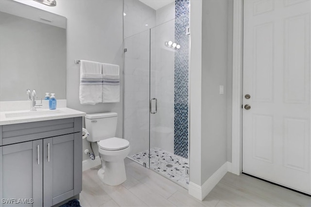 2312 4th Ave SE, Naples, FL 34117 - full bathroom with a shower stall, vanity, baseboards, and toilet
