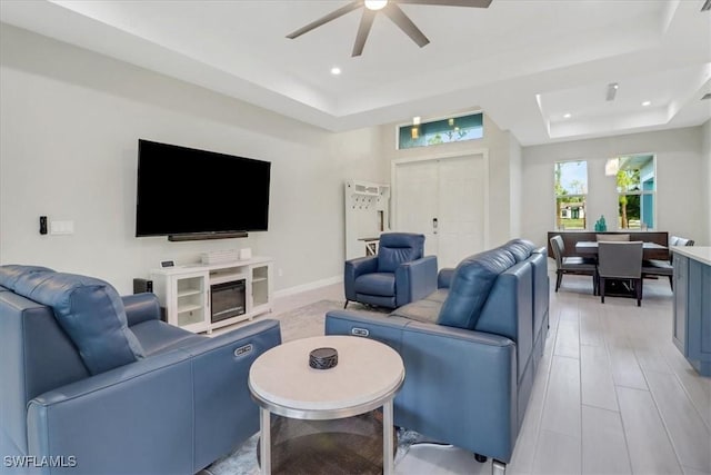 2312 4th Ave SE, Naples, FL 34117 - living area with a tray ceiling, light wood-type flooring, a ceiling fan, recessed lighting, and baseboards