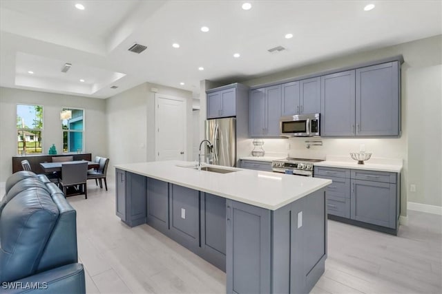 2312 4th Ave SE, Naples, FL 34117 - kitchen with open floor plan, light countertops, visible vents, a raised ceiling, and stainless steel appliances