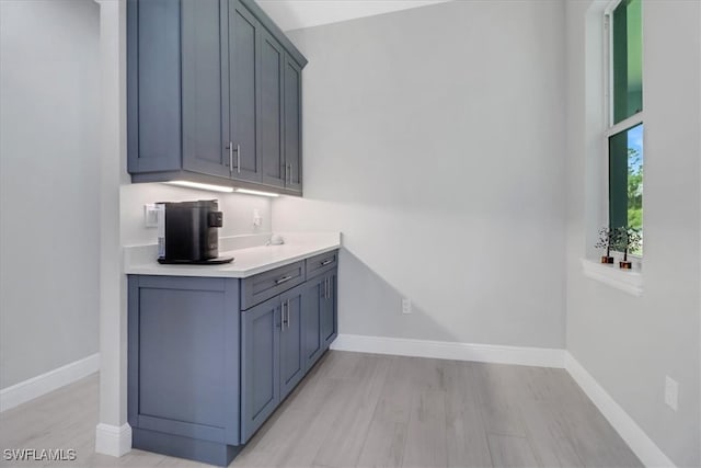 2312 4th Ave SE, Naples, FL 34117 - bar with baseboards and light wood-style floors