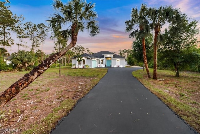 2312 4th Ave SE, Naples, FL 34117 - view of front of property with aphalt driveway and a yard