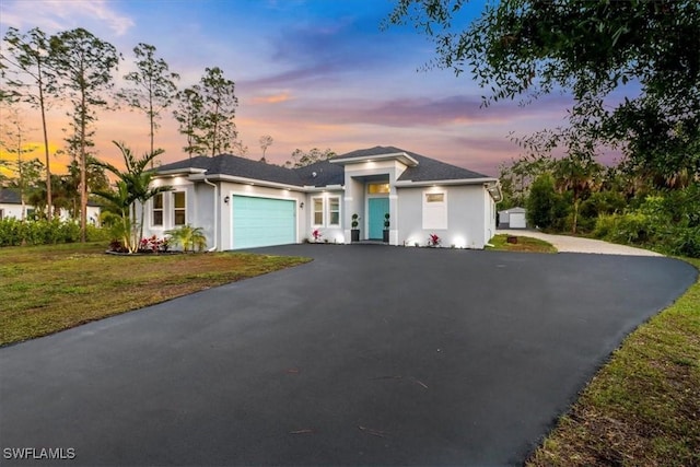 2312 4th Ave SE, Naples, FL 34117 - view of front of property featuring an attached garage, aphalt driveway, stucco siding, and a front lawn