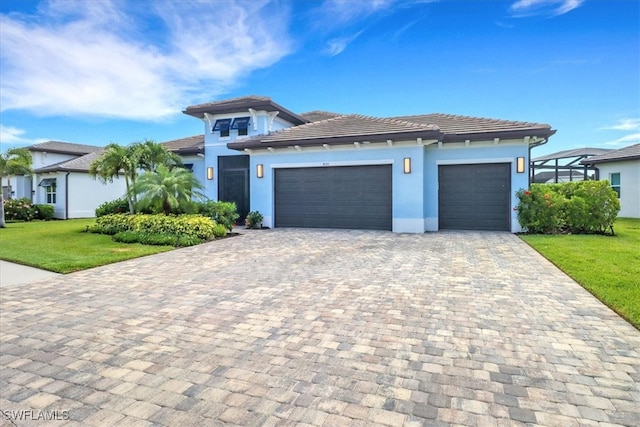 3721 Sapphire Cove Cir, Naples, FL 34114 - view of front of house featuring an attached garage, decorative driveway, a front yard, and stucco siding